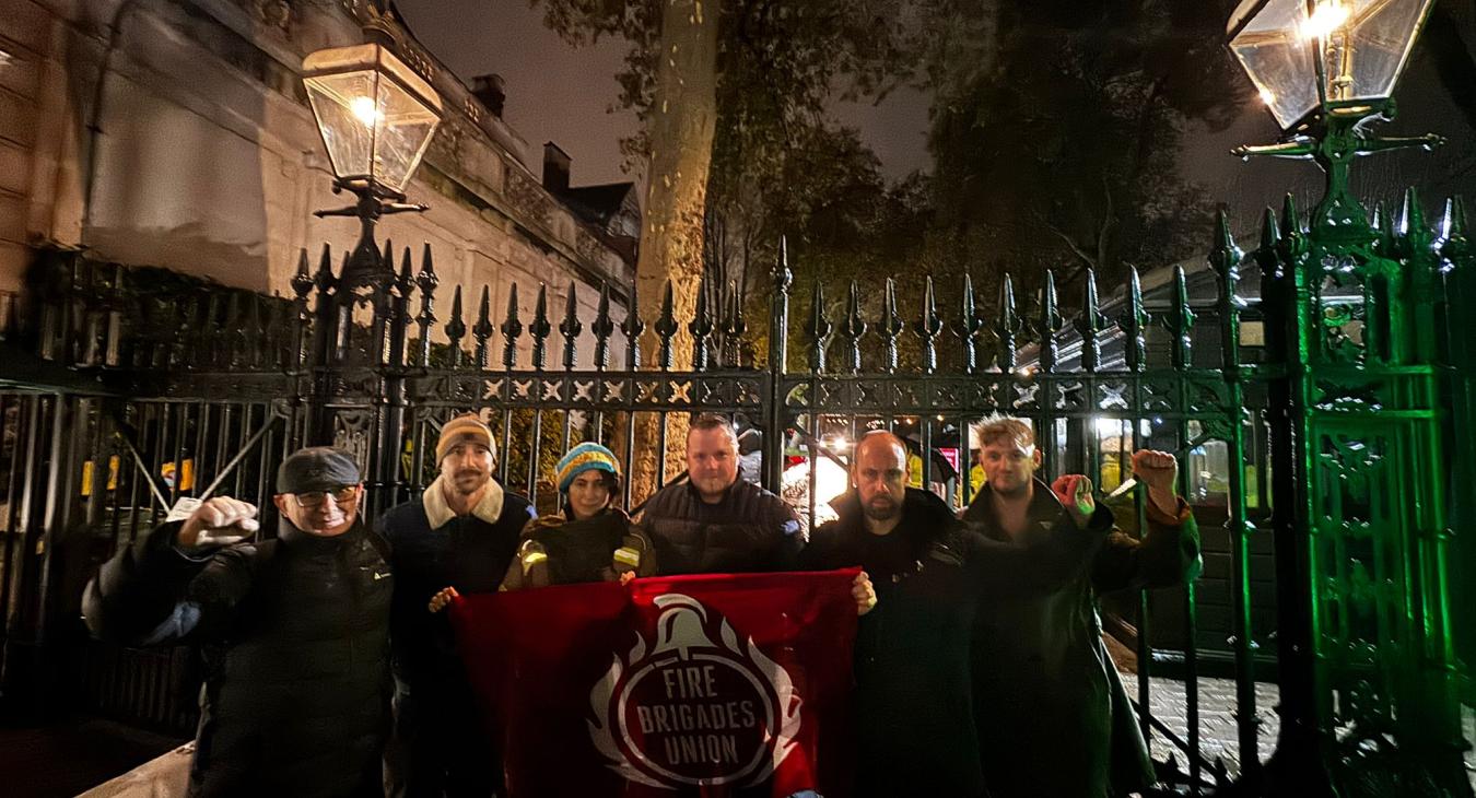 Group of protestors holding FBU flag outside Israeli embassy gates