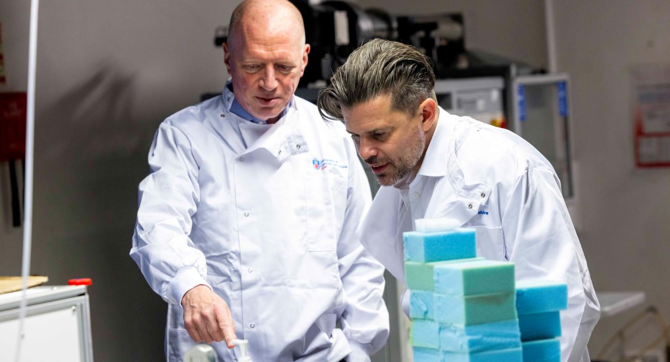 Matt Wrack and Riccardo la Torre in lab coats at the university of central lancashire