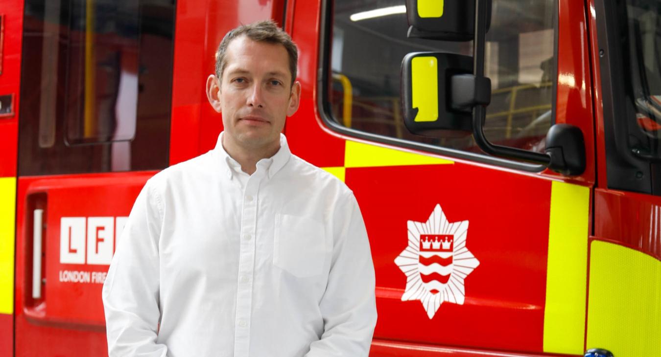 Steve Wright standing in front of a fire engine at Kingston fire station