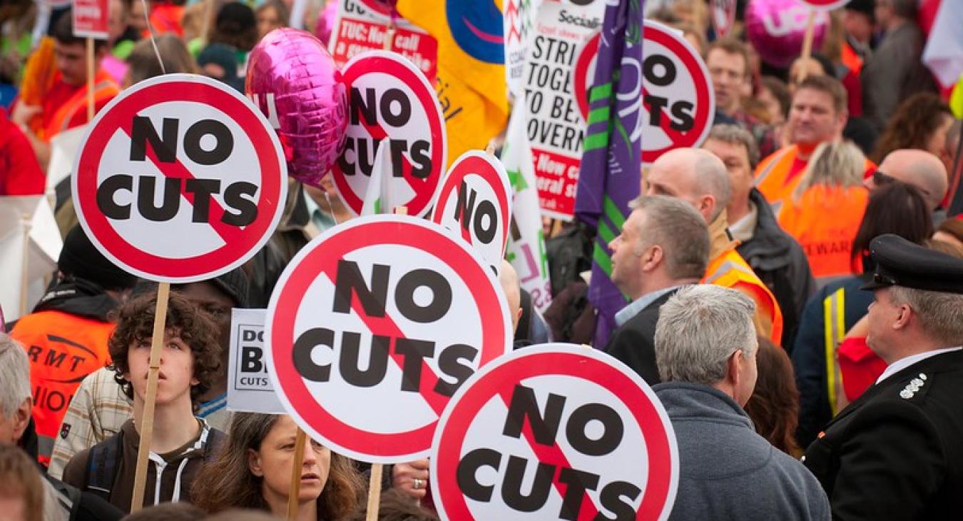 Protestors hold 'no cuts' placards