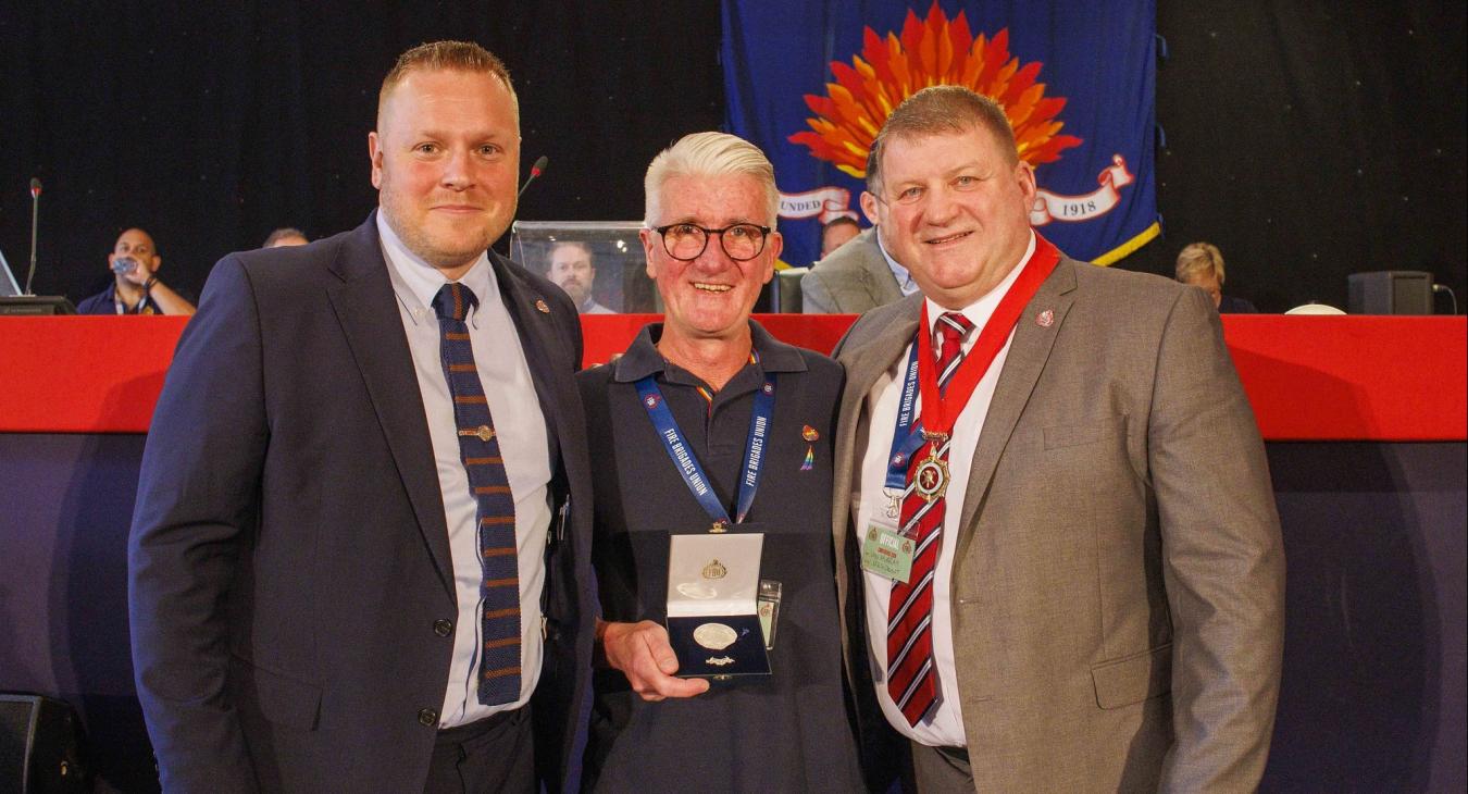 Pat Carberry recieving his solidarity medal from Ben Selby and Ian Murray