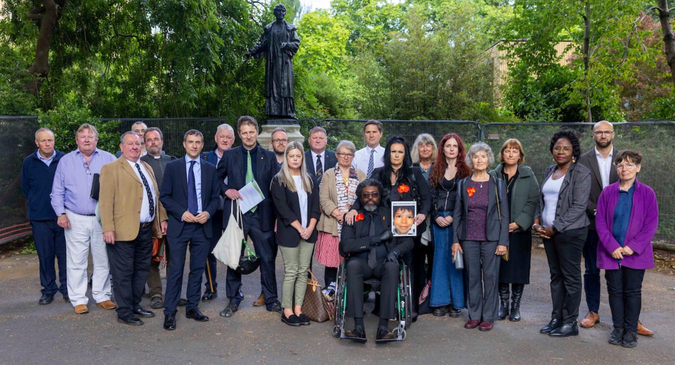 Group photo of campaigners and MPs outside college green