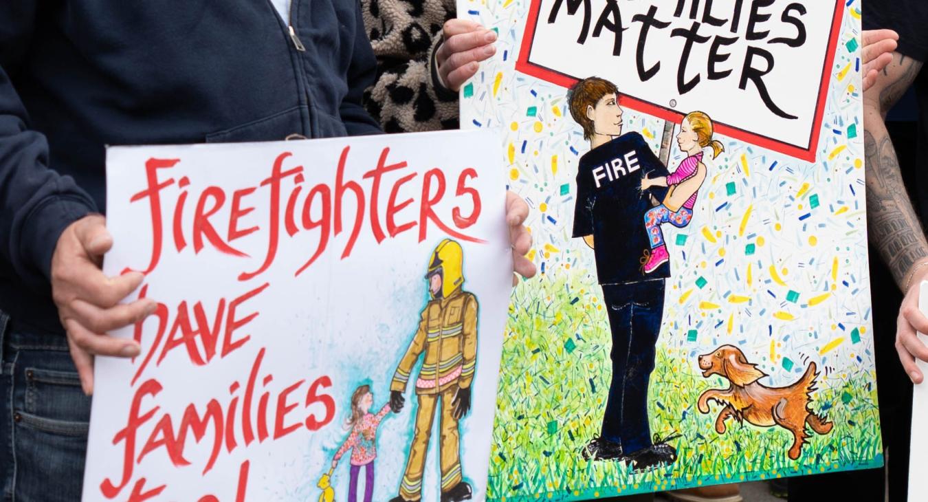Protestors hold signs saying "our families matter"