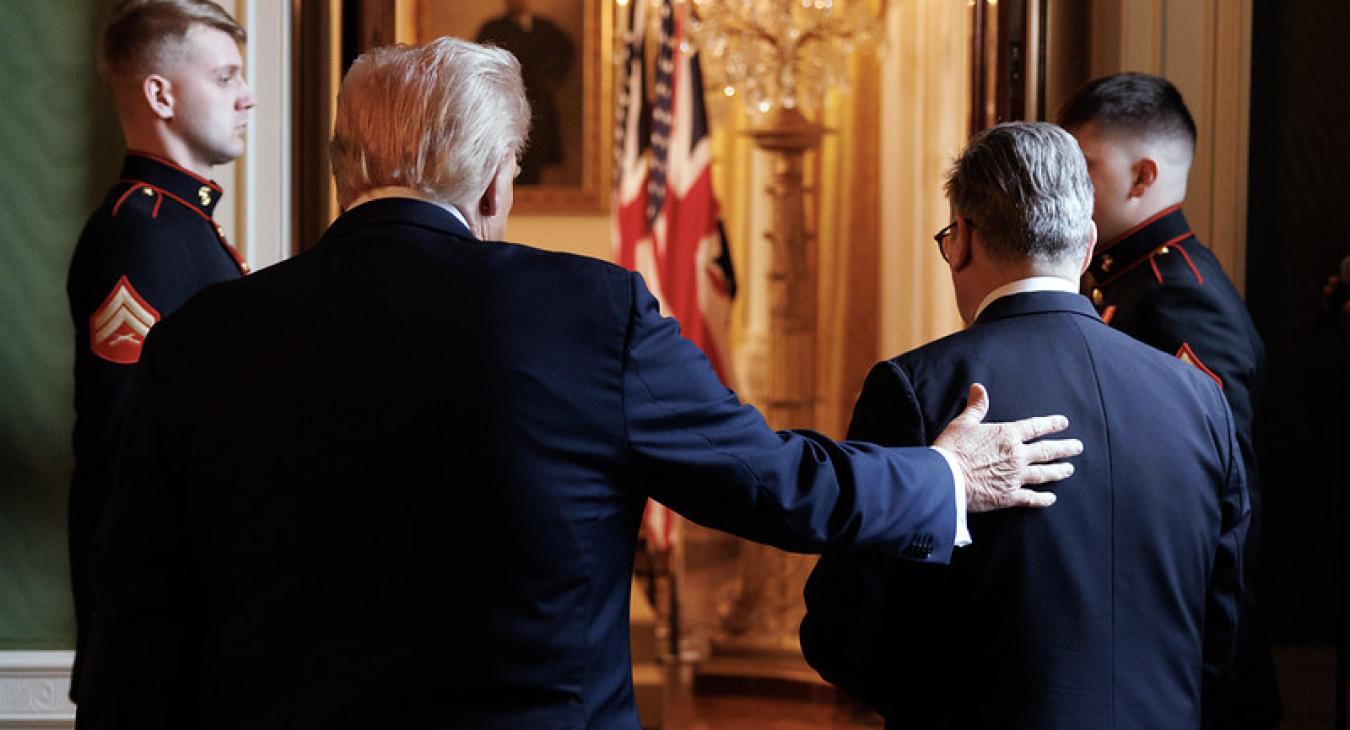 Donald Trump puts his hand on Keir Starmer's back as they face away from the camera