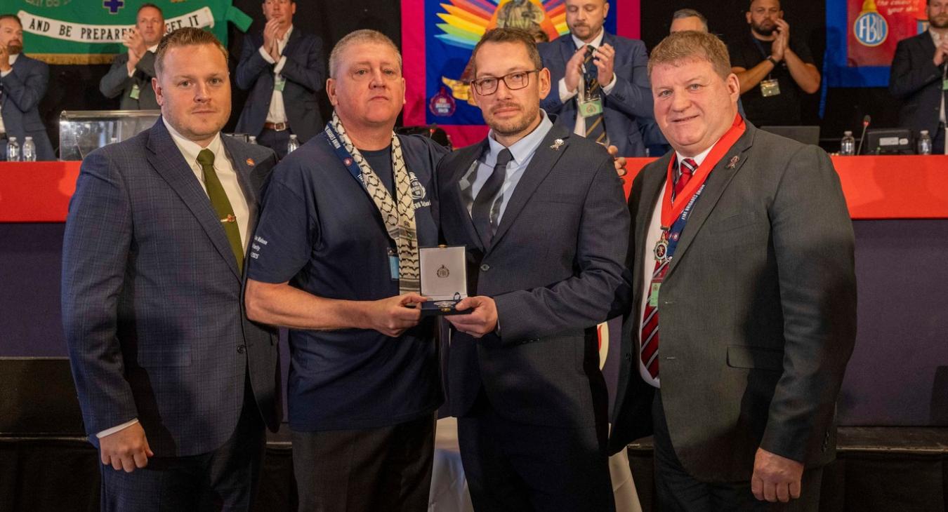 Ben Selby (AGS), Steve Wright (GS) and Ian Murray (President) present Jim Malone with a solidarity medal