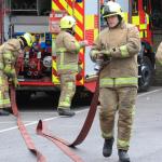 Firefighters pulling our hose appliance