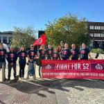 FBU members hold Fight 52 banner outside fire authority building