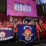 FBU members on stage at rally holding Inverness FBU banner 