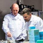 Matt Wrack and Riccardo la Torre in lab coats at the university of central lancashire