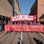 Workers from the GKN factory march with a banner reading "rise up" in Italian