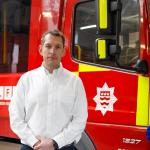Steve Wright standing in front of a fire engine at Kingston fire station