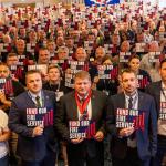 FBU conference 2025 delegates holding signs saying fund our fire service