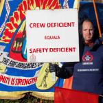 FBU member holds up a sign reading 'crew deficient equals safety deficient'