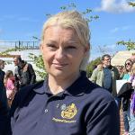 Rebecca Lewington smiling at camera wearing FBU polo shirt