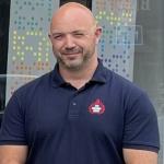 Mark Thomas standing looking at camera in FBU polo shirt
