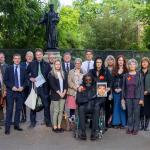 Group photo of campaigners and MPs outside college green