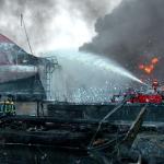 Firefighters fighting Buncefield fire with foam