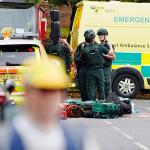 Paramedics talking in front of ambulance in the road 