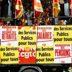 A float covered in posters in French at a strike rally