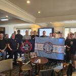 Members with a Trades Union Blues banner at an FBU meeting