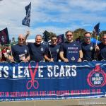 FBU members holding large banner reading 'cuts leave scars' with FBU logo