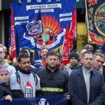 A crowd of firefighters with banners outside Oxfordshire county hall