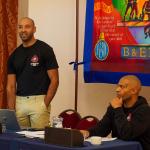 Adam McKenzie standing in front of an FBU banner at an event